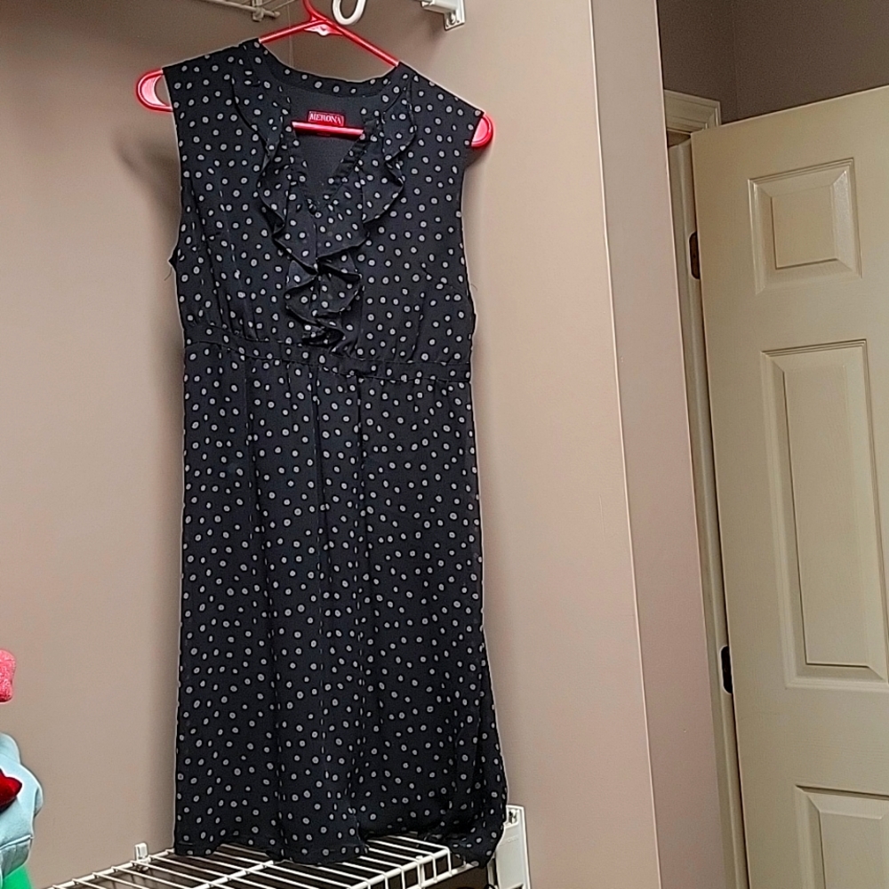 Sleeveless polka-dot dress with ruffles around the v-neck